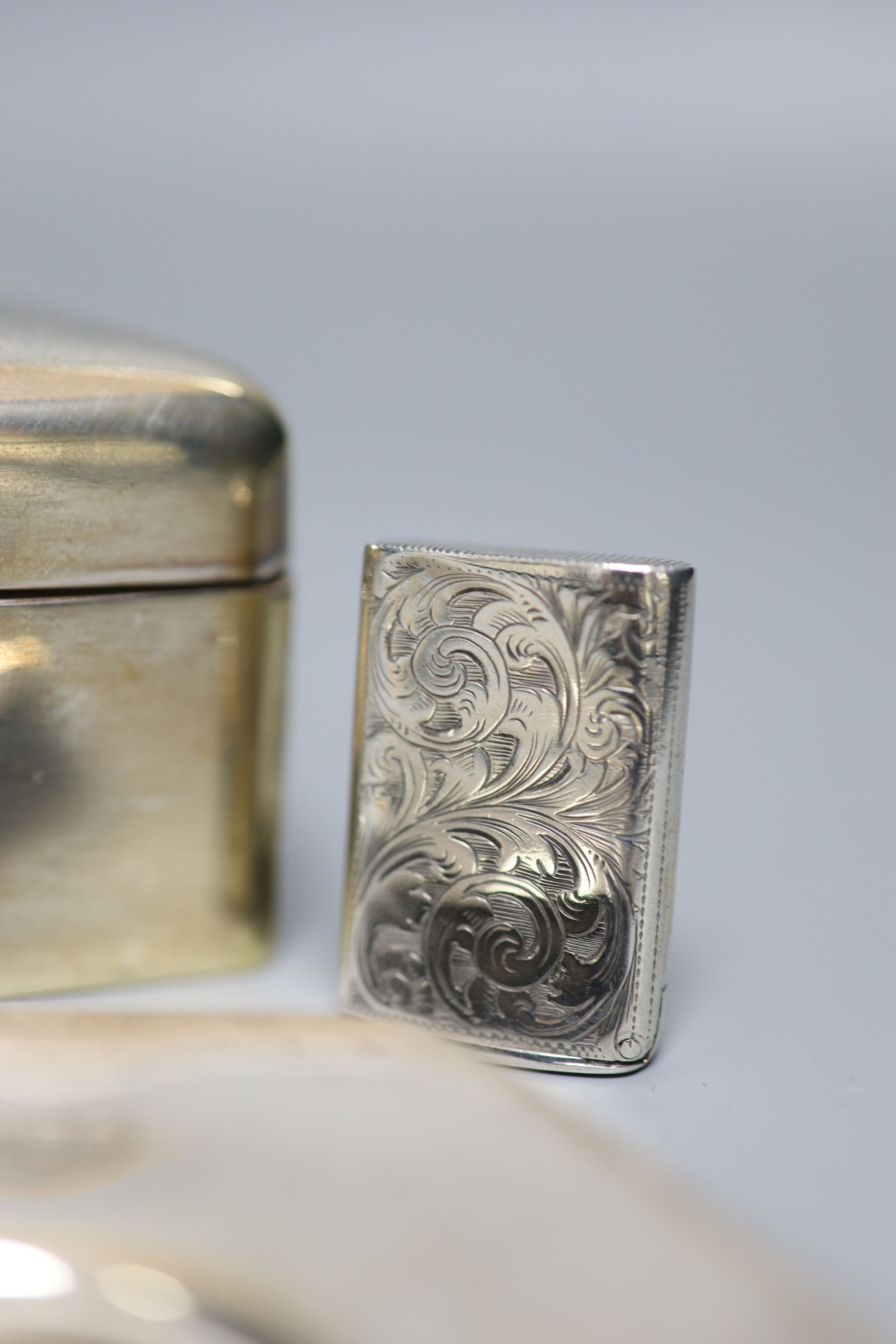A silver cigarette box (marks rubbed), 14cm, a modern silver commemorative dish and a silver vesta case.